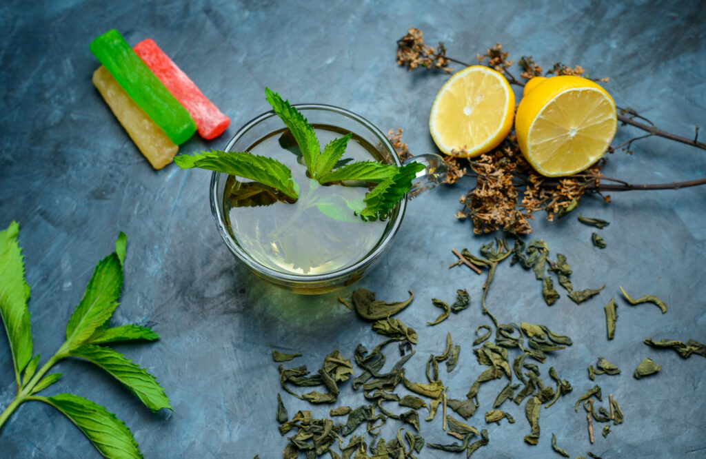 Tea in a cup with mint, dried herbs, lemon-Morning Sickness, herbal tea for Pregnancy