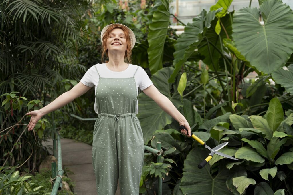 Woman enjoying a moment of mindfulness and stress relief in a lush sensory garden, integrating horticultural therapy techniques.