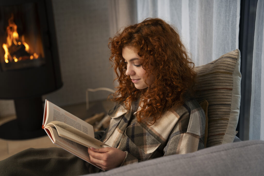 persone reding a book in her sofa