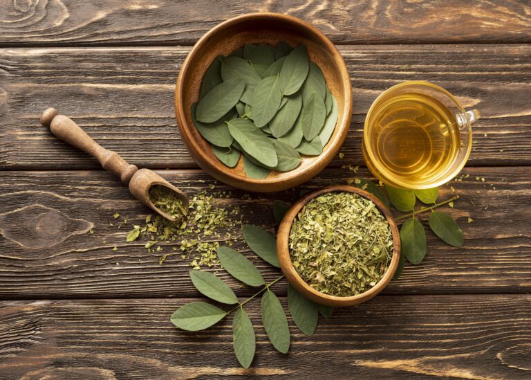 top view green leaves and cup of medicinal plants